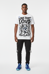 Male model wearing Love Hurt Loud graphic tee with Nike Zoom Kobe 5 Protro X-Ray sneakers