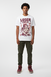 Male model wearing Loser In Love Zadago graphic tee with Air Jordan 3 Bin23 sneakers, studio background