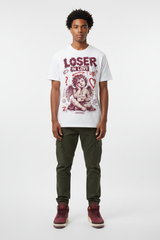 Male model wearing Loser In Love Zadago graphic tee with Air Jordan 3 Bin23 sneakers, studio background