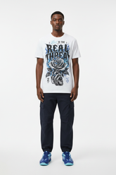 Male model wearing Love Is The Real Threat graphic tee with Nike Zoom Kobe 5 Protro X-Ray sneakers