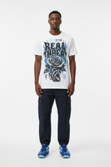 Male model wearing Love Is The Real Threat graphic tee with Nike Zoom Kobe 5 Protro X-Ray sneakers